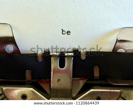 Be, one word typewritten on white paper on vintage manual typewriter machine
