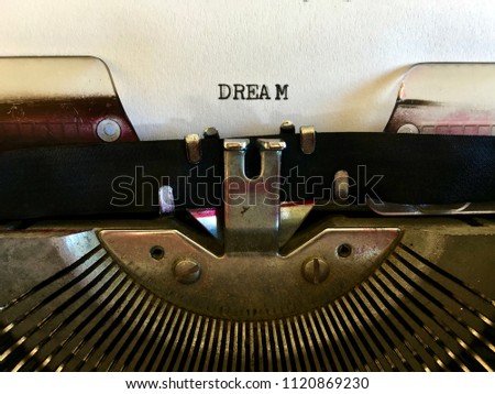 Dream, one word typed in black ink on white paper on vintage manual typewriter machine