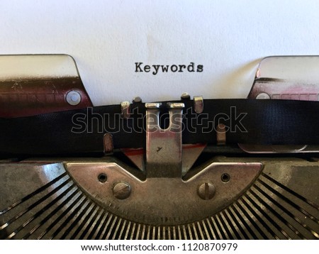 Keywords, heading title typewritten on vintage manual typewriter machine