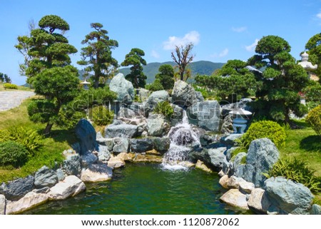 Little waterfall among the stones in asian garden