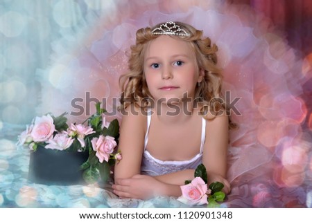 girl in white with pink dress and in a diadem on a sofa with flowers
