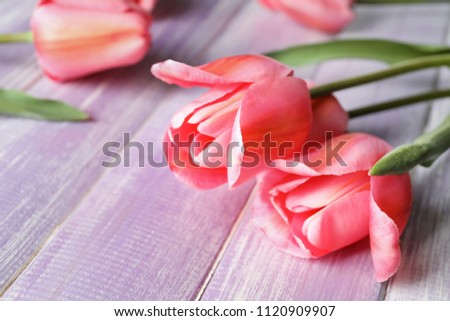 Beautiful tulips on wooden table