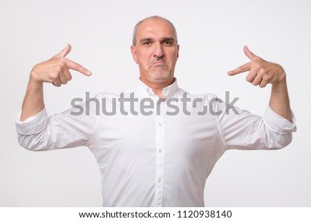 Man proud of himself over gray background. I am the best concept. Select me for success Royalty-Free Stock Photo #1120938140