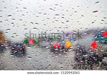 Blur picture: rain through the glass on the road
