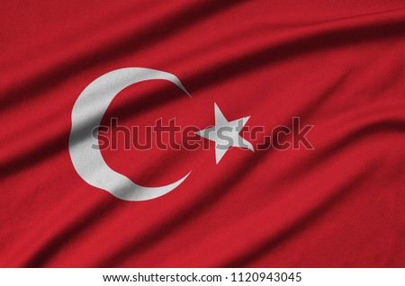 Turkey flag  is depicted on a sports cloth fabric with many folds. Sport team banner Royalty-Free Stock Photo #1120943045