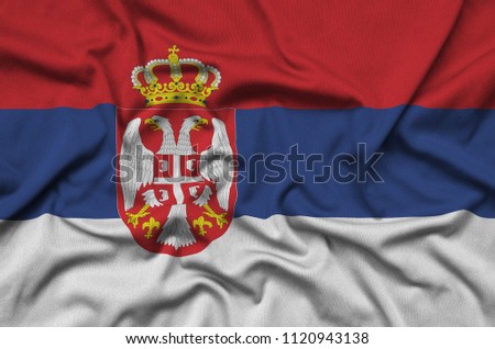 Serbia flag  is depicted on a sports cloth fabric with many folds. Sport team banner