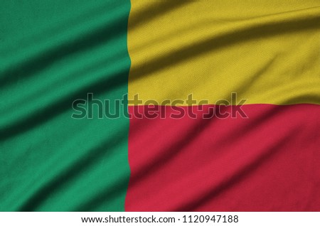 Benin flag  is depicted on a sports cloth fabric with many folds. Sport team banner