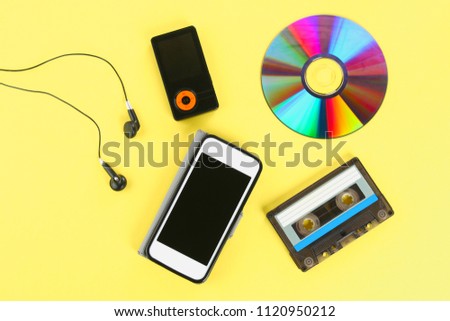 The concept of the evolution of music. Cassette, CD-disk, mp3 player, mobile phone. Vintage and modernity. Music support.