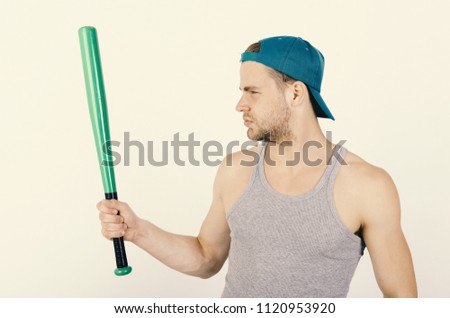 Guy in grey tank top holds bright green bat. Player with serious face plays baseball. Sports and baseball training concept. Man in cyan green cap on white background.