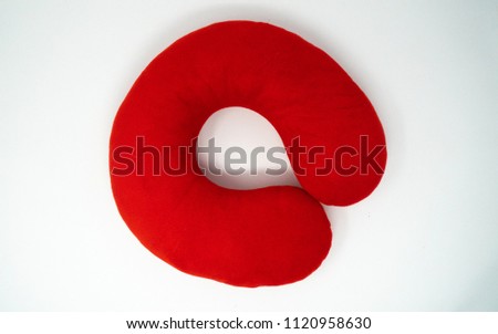 Red neck pillow, isolated on white background Royalty-Free Stock Photo #1120958630