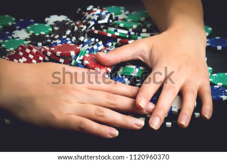 victorious rejoicing to all chips after poker game, greedy woman taking all money, toned image