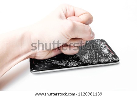 Fist hand onto black mobile phone with broken screen ,selective focus,isolated on white background