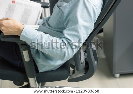 Business man working on his computer in an ergonomic office chair Royalty-Free Stock Photo #1120983668