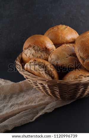 fresh, crunchy spelt rolls, sourdough with napkin on a dark slate plate kitchen table