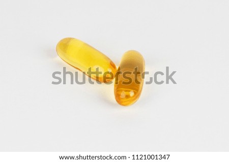 Fish oil supplement capsules source of omega3 selective focus in front object isolated on white background.