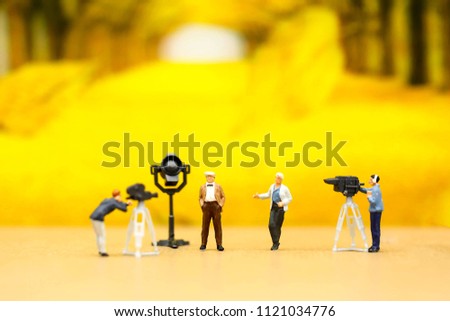 Miniature people : Actress in front of the camera on the film set with Spring Background , Group movie scene