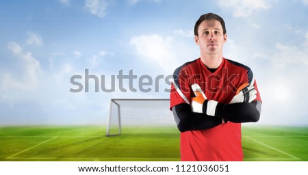 Digital composite of Soccer goalkeeper folding arms in goal