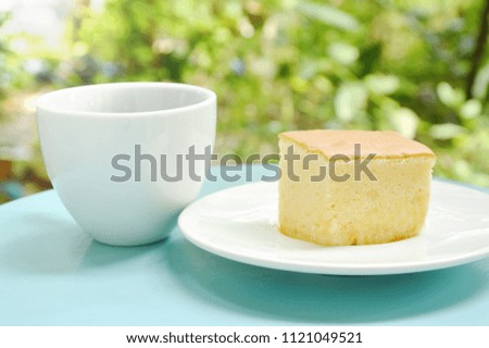 butter cake slice for piece on plate and black coffee cup