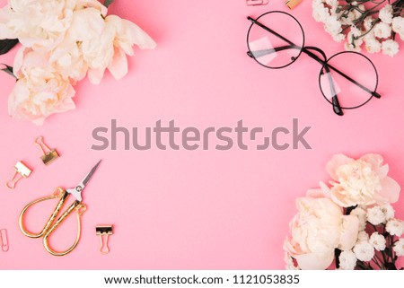 Beautiful romantic summer workspace. Stationary on pink background with peonies and copy space