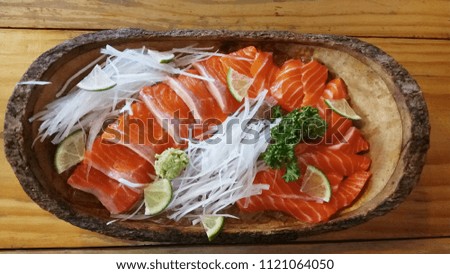 salmon raw sashimi in the wooden dish on the wooden table, Japanese food