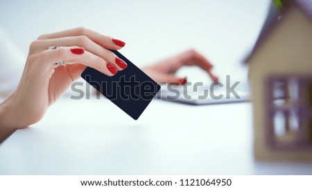 Invest in real estate concept. woman makes a payment with a credit card for the purchase of real estate on credit.