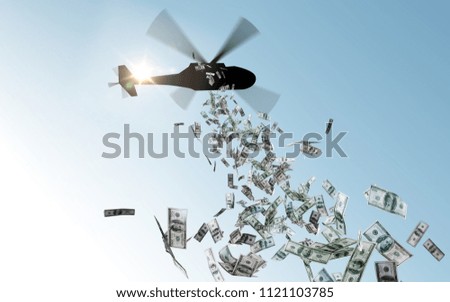 finance, economy and monetary policy concept - helicopter dropping money in sky Royalty-Free Stock Photo #1121103785