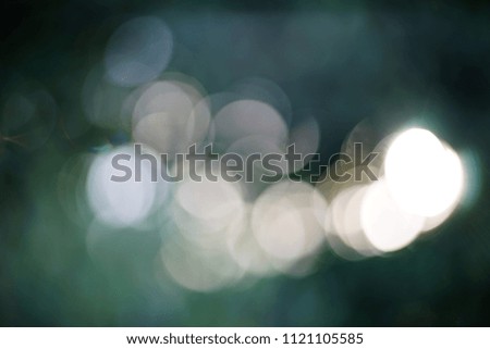 Abstract blurred bokeh background. White circles on blue green shades