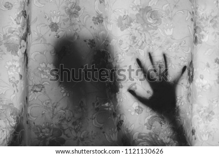 Black and white image of mysterious human shadow behind a curtain. fear, Mystery, scary, creepy and paranormal concept Royalty-Free Stock Photo #1121130626