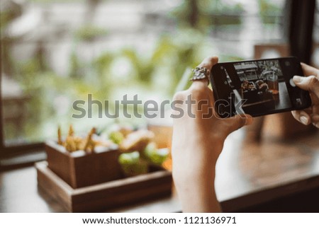 woman capturing photos of food.