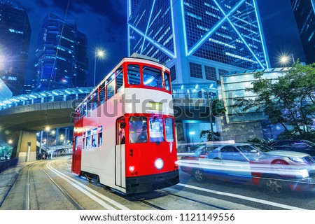 Retro tram on the evening city street. Hong Kong.