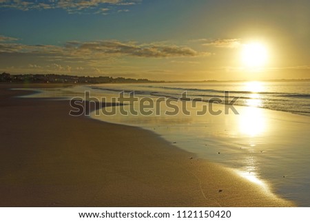 A beautiful sunrise over Meia Praia with an incoming tide, Lagos, The Algarve, Portugal