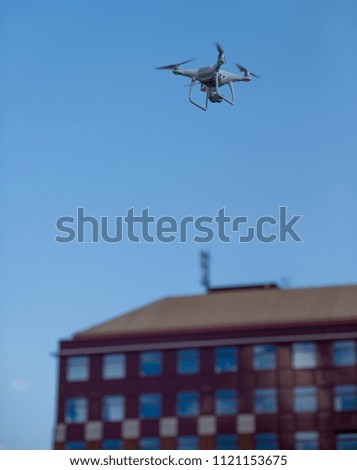 White drone in front of a building