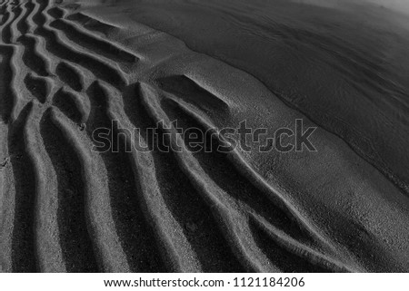 abstract sand ornament on the beach , 
black and white photography
