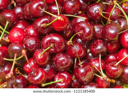 Fresh cherries. cherry in a green plate on a wooden background.