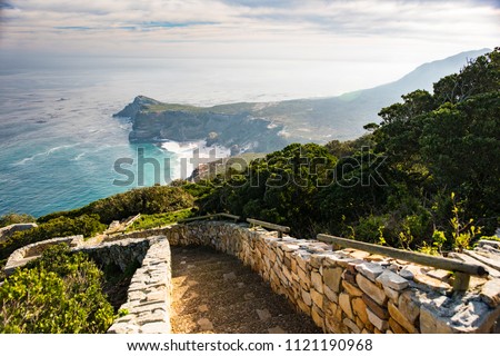 Stones steps going to the the rocks cliffs at the Cape of Good Hope in South Africa. Royalty-Free Stock Photo #1121190968