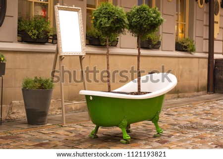A green bath is standing on the street ..