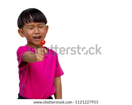 Focus picture on A red lollipop in hand of Cute asian little boy wearing pink t-shirt, Action isolate on white background