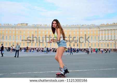A young girl roller-skates in the Palace square in St. Petersburg.