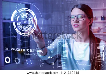 Large icon. Clever experienced progressive teacher thoughtfully looking at eh diagram on the transparent screen and touching it while getting ready for the lesson Royalty-Free Stock Photo #1121310416