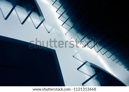 Stair-step structure. Tilt double exposure photo of modern architecture fragment glowing in darkness. Unusual / surreal abstract architectural or industrial background in hi-tech style.