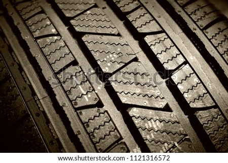 Tyre treads texture, dark abstract background