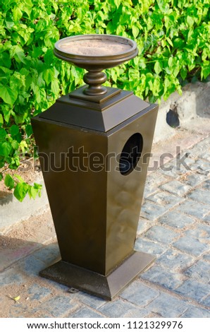 Metal urn with ashtray on street in Soho Square, Sharm El Sheikh, Egypt Royalty-Free Stock Photo #1121329976