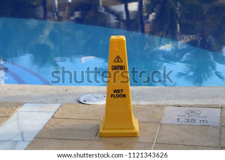 Caution / Yellow column near the pool, warns of danger