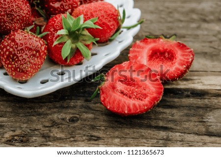Ripe juicy red strawberries, on a blurred background. Close up. Selective focus