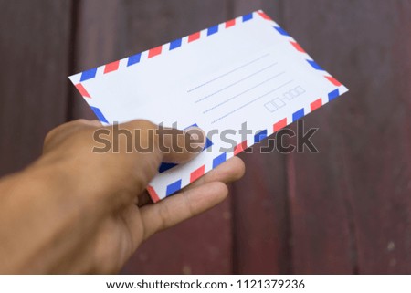 Cropped hand in photo for give the envelope