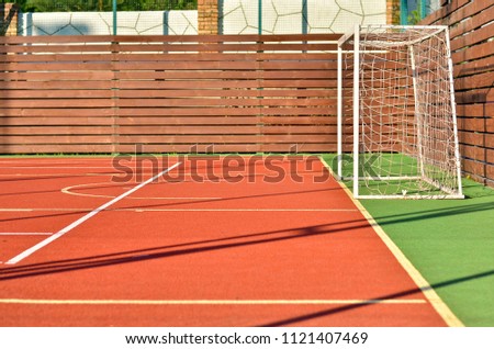 Close up of a soccer goals on an outdoors mini football field with artificial cover.
