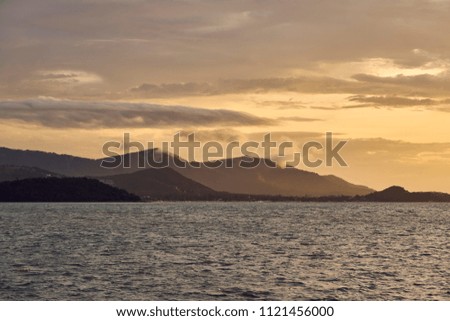                     Spectacular sunset over sea lagoon and mountains             
