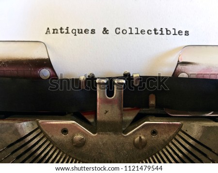 Antiques and Collectibles, typewritten heading  on white paper on vintage retro manual typewriter machine