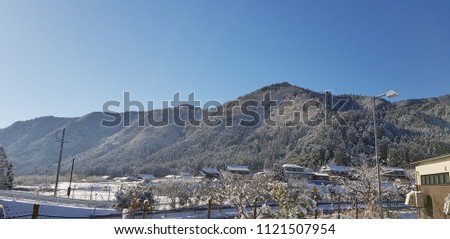 Village in the snow moutain and bright sky