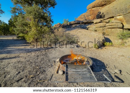 USA, Nevada, Lincoln County, Big Rock Wilderness. Campfire at the Mecca climbing area camp site. Royalty-Free Stock Photo #1121566319